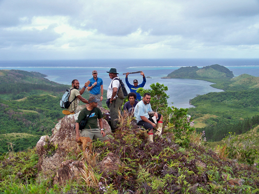 people standing on top of a hillside in fiji