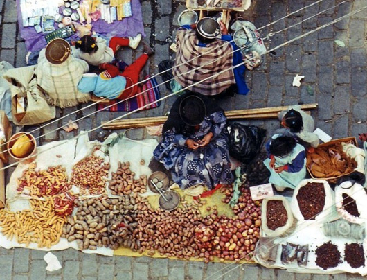 view of market trader in the andes with huge collcetion of potatoes